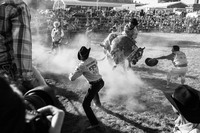 Cowboys attempting to tame the bull at the Newburgh Tierra Caliente Rodeo