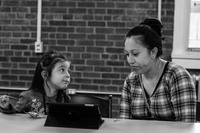 A  young girl shows her mother how to use an iPad at The Newburgh Amory Untiy Center. 