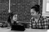 A  young girl shows her mother how to use an iPad at The Newburgh Amory Untiy Center. 