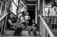 On a sunny Saturday on Dubois Street, a Newburgh family enjoying their front porch.
