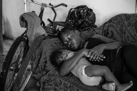 Candy and her son sleeping in a home they share in the Gungulung neighborhood in Belize City where the poorest people live and have little access to cervical cancer screening