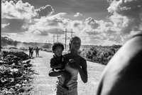 A girl holding a friend's baby in The Gungulang neighborhood in Belize City where the vunerable and at risk people live-known as the forgotten land.