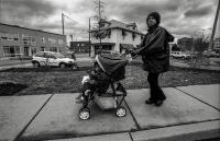 It is a long walk from the daycare center back to their apartment. The weather is cold and damp and the young family is not yet used to their new schedule.
